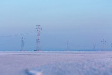 winter landscape, frozen river power line
