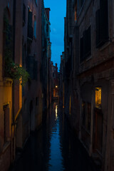 Fototapeta na wymiar beautif narrow water canal at the blue hour in Venice Italy