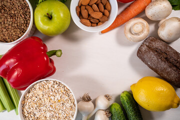 Selection of healthy food: salmon, fruits, seeds, cereals, superfoods, vegetables, leafy vegetables on a stone background. Healthy food for people.