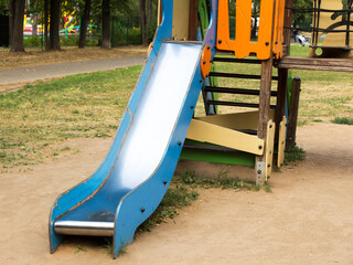 Children's plastic slide on the playground in the park
