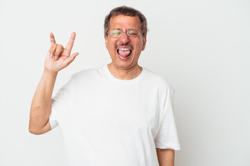 Fototapeta premium Middle aged indian man isolated on white background showing rock gesture with fingers