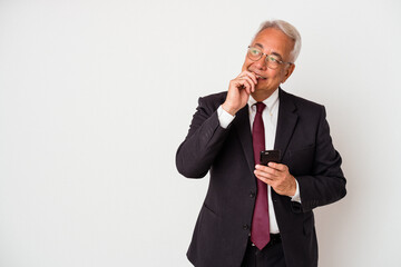 Senior business american man holding mobile phone isolated on white background relaxed thinking about something looking at a copy space.