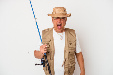 Senior american fisherman holding rod isolated on white background screaming very angry and aggressive.