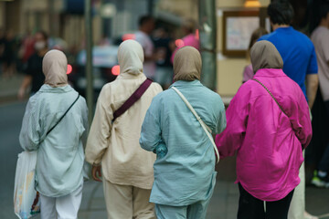 Asian women walking on the Moscow city street in hot summer day. Patriarch Ponds area. Lifestyle...
