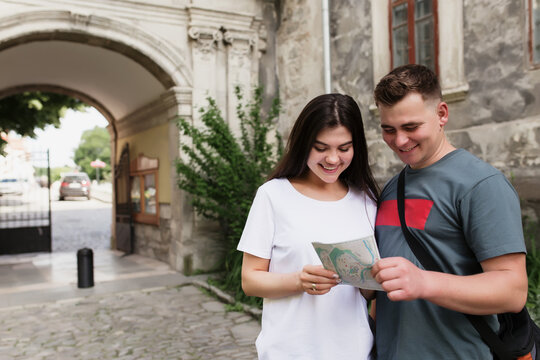 Couple Of Tourists In Love Looking At City Map To Understand How To Find A Place