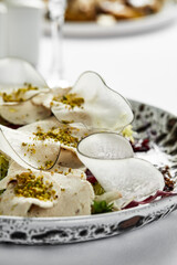 Vitello tonnato tender beef appetizer with tuna sauce, close-up.