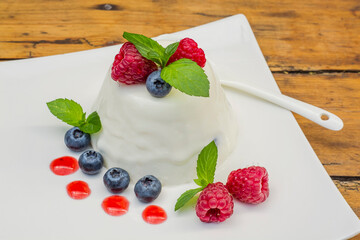 Great panacotta dessert with raspberries and blueberries