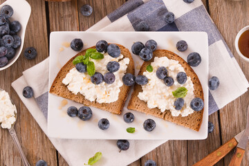 Rye bread with cottage cheese, blueberries and honey.