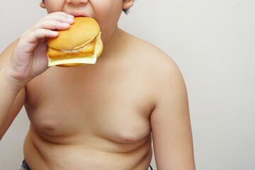The fat boy is happily for eating hamburger with a white background.