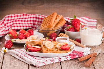 Waffles with strawberries, bananas and honey.