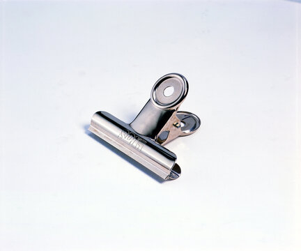 Closeup of a silver metal clip isolated on a clean white background