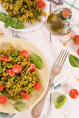 Fusilli pasta with cherry tomatoes and peas.