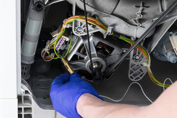 close-up of troubleshooting the wiring of the washing machine after a leak in the control unit