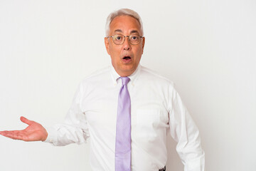 Senior american man isolated on white background impressed holding copy space on palm.