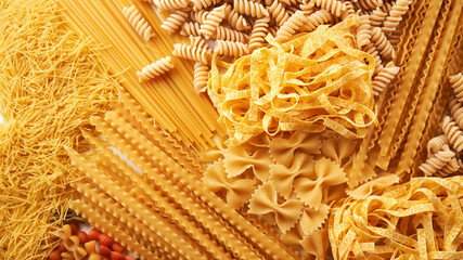 Assorted varieties of pasta background. Mix macaroni - obrazy, fototapety, plakaty