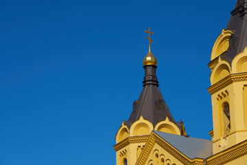 Fototapeta na wymiar The dome of the church against the clear blue sky.