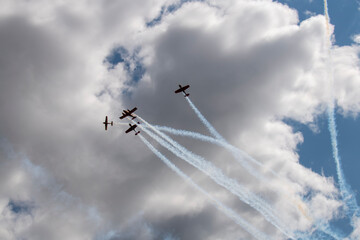 a beautiful plane makes a difficult turn leaves a white trail of flight against the background of the sky