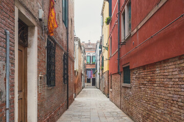 Narrow alley between traditional Venetian houses, Venice, Italy