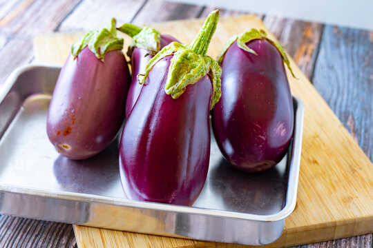 Close up to fresh organic eggplants on wooden table
