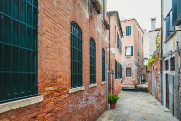 Narrow alley between traditional Venetian houses, Venice, Italy