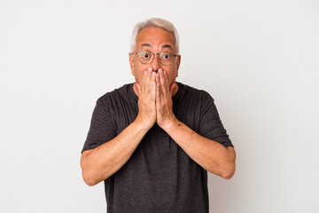 Senior american man isolated on white background shocked, covering mouth with hands, anxious to discover something new.