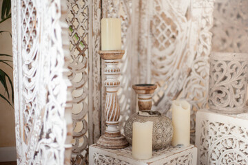 Candles on the background of the boho wall. Indian corner for meditation in the bedroom. A place of power, esoteric rituals