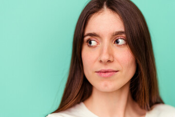 Fototapeta premium Young caucasian woman isolated on blue background
