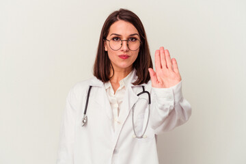 Young doctor caucasian woman isolated on white background standing with outstretched hand showing stop sign, preventing you.