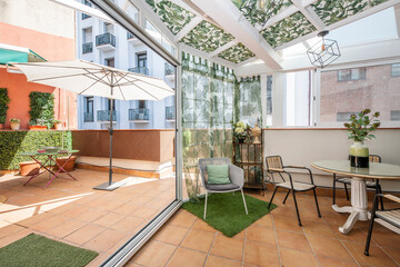 Large terrace in a holiday rental apartment with one part covered and the other with awnings and sun screens
