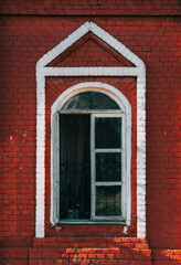 old window in a church building, red brick wall
