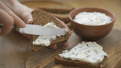 Making healthy sandwiches with cottage cheese.Cream cheese spread on rye bread.