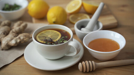 Put a teaspoon of honey in a Cup of hot tea with lemon. Close up.