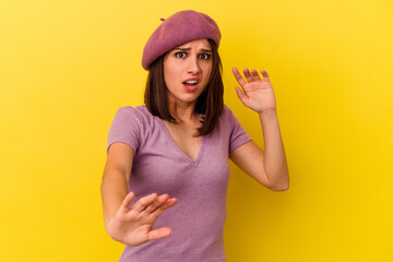 Young caucasian woman isolated on yellow background being shocked due to an imminent danger