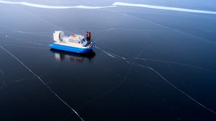Coast Guard. Rescuers on board a hovercraft among the ice. Shooting from a drone. Copy space.