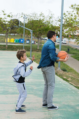 Stylish young boy, teenager is playing with ball, outdoors