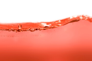 Orange red clean water surface with water drops and waves.
