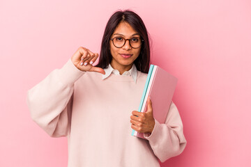 Young student latin woman isolated on pink background feels proud and self confident, example to follow.