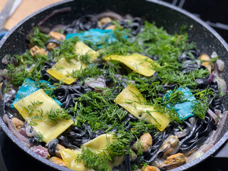 Black pasta with mussels and cheese
