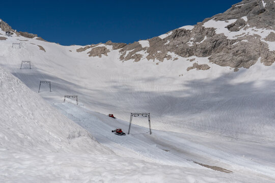 Snow moving vehicles on the Schneeferner glacier below the Zugspitze in Germany.