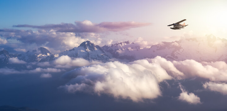 Airplane flying near the Beautiful Canadian Mountain Nature Landscape. Adventure Composite. Dramatic Sunset Sky. Background from near Squamish and Vancouver, British Columbia, Canada.