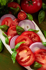 Salad with tomatoes, basil, and red onion.