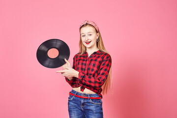 Beautiful pin-up girl with vinyl discs on pink background. Young pin up woman in stylish vintage clothes with vinyl record.