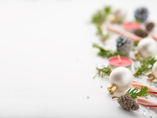 Fototapeta na wymiar Christmas. New Year. Creative handmade composition of cones, Christmas tree branches, candles. Blurred background. White background. Pastel shades.