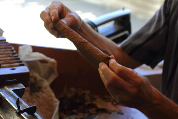 man preparing cigars in his miami shop