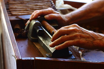 man preparing cigars in his miami shop