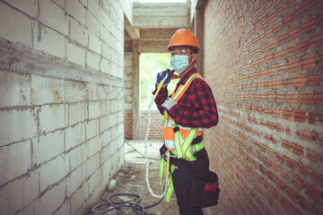 Portrait man worker in the safety uniform at construction site