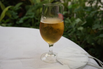 Beer and a FFP2 mask on a table