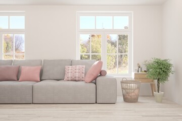 Stylish room in white color with sofa and autumn landscape in window. Scandinavian interior design. 3D illustration