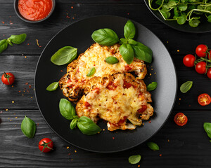 Baked Cauliflower steak with marinara sauce and cheese on plate. Healthy vegetarian food