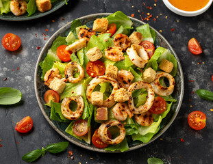 Grilled squid or calamari and shrimp salad with garlic croutons and cherry tomatoes. healthy food.